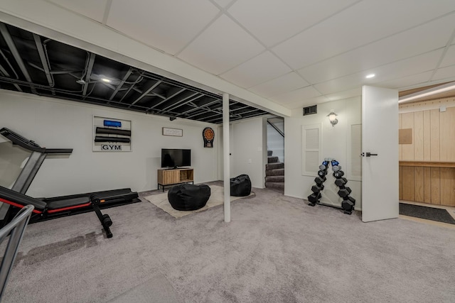 exercise area with carpet floors, visible vents, and a drop ceiling