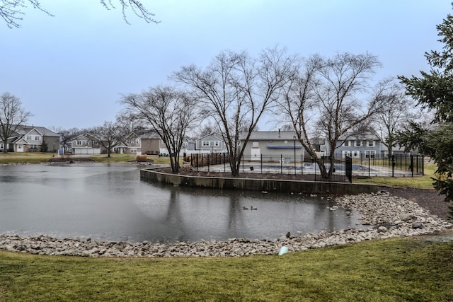 view of water feature featuring fence and a residential view