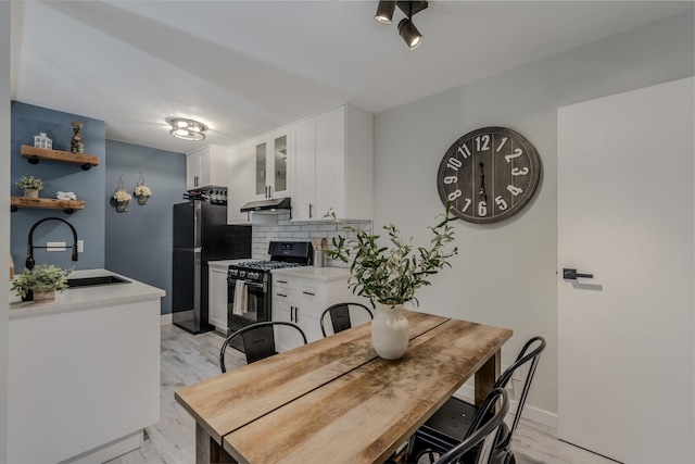 dining room featuring light wood finished floors and baseboards