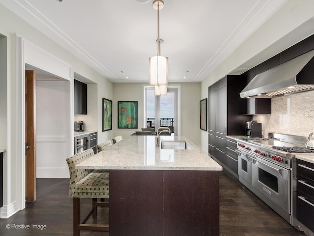 kitchen with range with two ovens, dark wood-style flooring, a sink, and backsplash