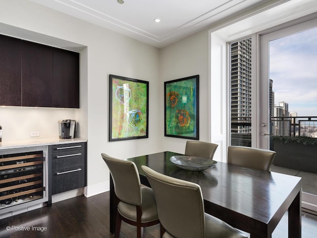 dining space with dark wood-type flooring, wine cooler, baseboards, and recessed lighting