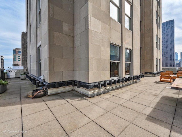 view of patio / terrace with entry steps and a city view