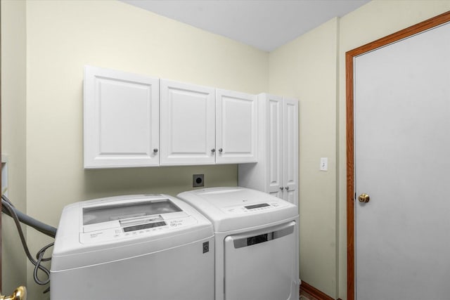 laundry room with cabinet space and separate washer and dryer