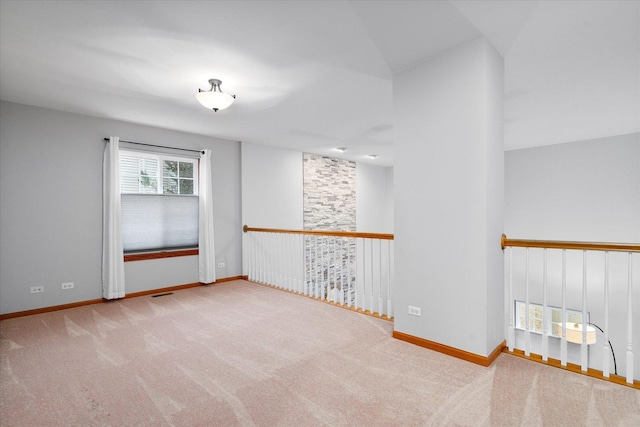 carpeted spare room with visible vents and baseboards