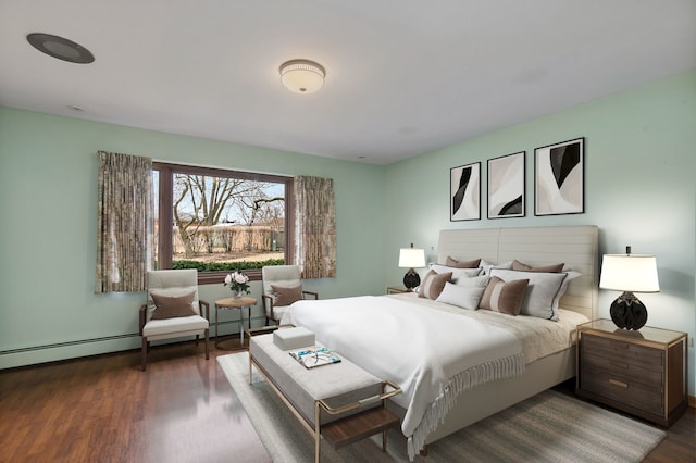 bedroom with a baseboard radiator and wood finished floors