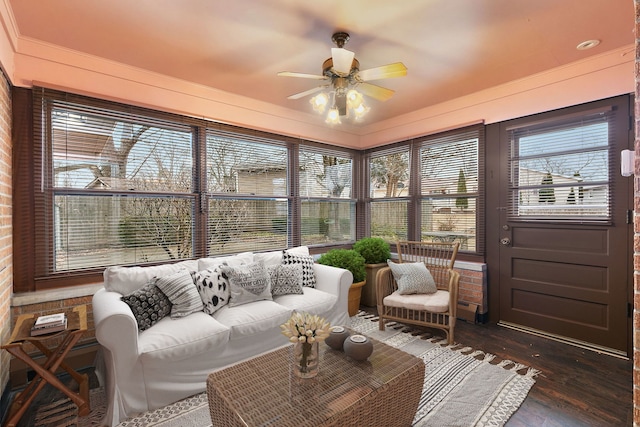 sunroom / solarium with a ceiling fan