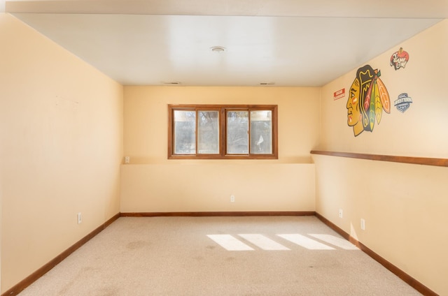 carpeted spare room with baseboards