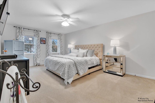 bedroom with a ceiling fan, light colored carpet, and baseboards