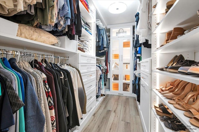 walk in closet with light wood-type flooring