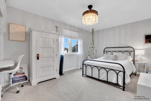 bedroom with a chandelier, carpet flooring, and baseboards