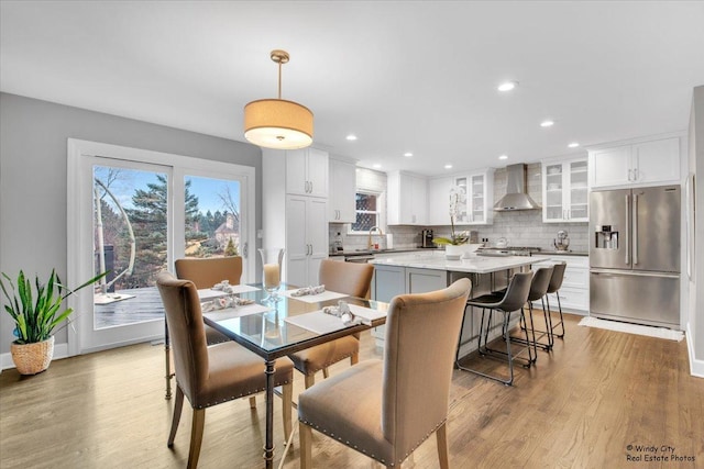 dining room with light wood finished floors and recessed lighting