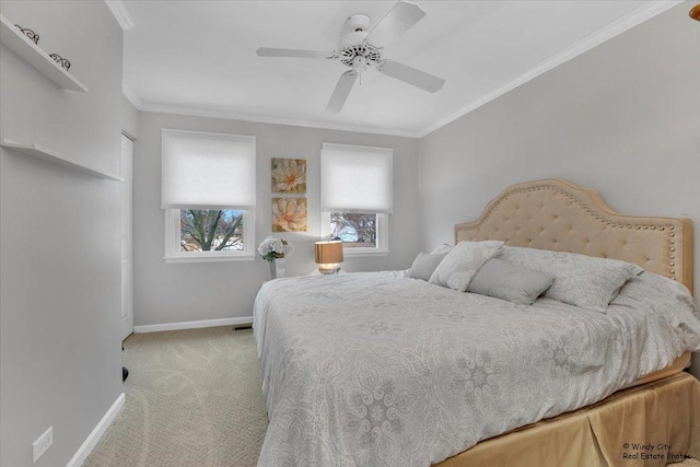 carpeted bedroom featuring a ceiling fan, crown molding, and baseboards