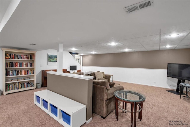 living room featuring carpet floors, visible vents, and a drop ceiling