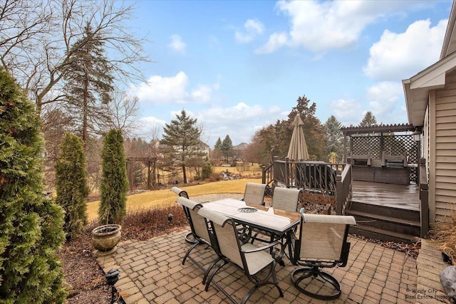 view of patio featuring a deck, outdoor dining area, and a pergola