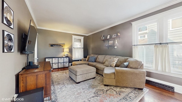 living area featuring a wealth of natural light, baseboards, wood finished floors, and ornamental molding