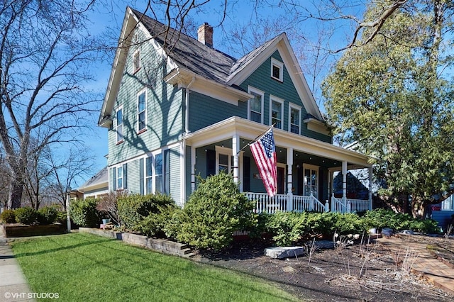 view of front of home with a porch and a front lawn