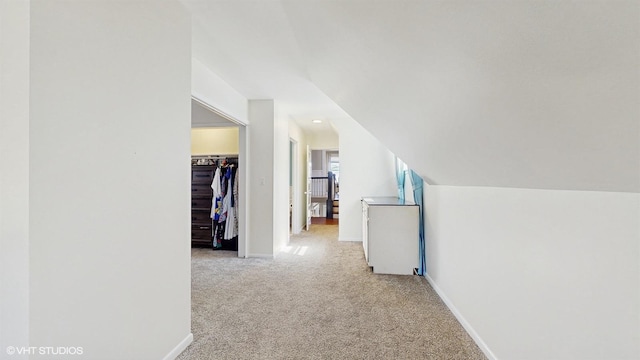 additional living space featuring baseboards, carpet, and vaulted ceiling