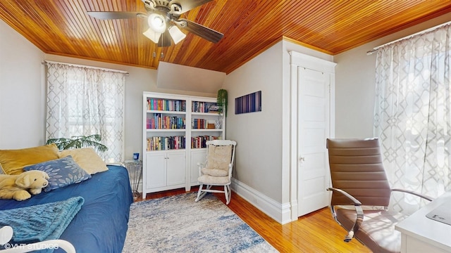 living area featuring light wood-type flooring, ornamental molding, wooden ceiling, baseboards, and ceiling fan