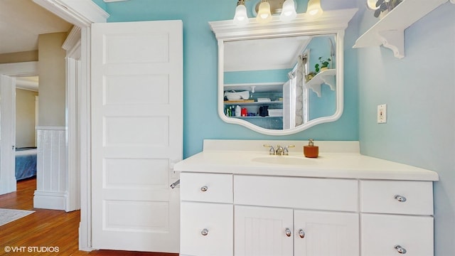 bathroom with vanity and wood finished floors