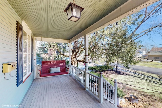 wooden terrace featuring covered porch