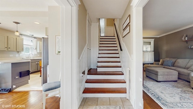 stairs with tile patterned flooring, visible vents, and crown molding