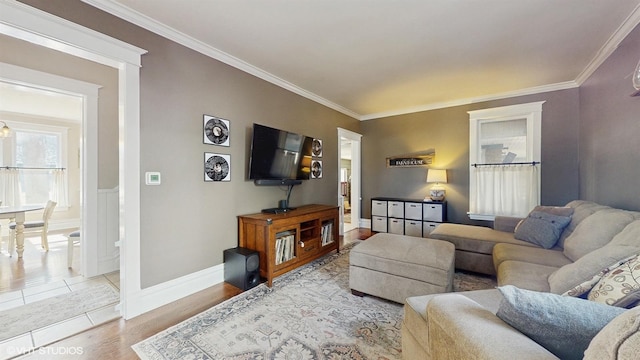 living area featuring wood finished floors, baseboards, and ornamental molding