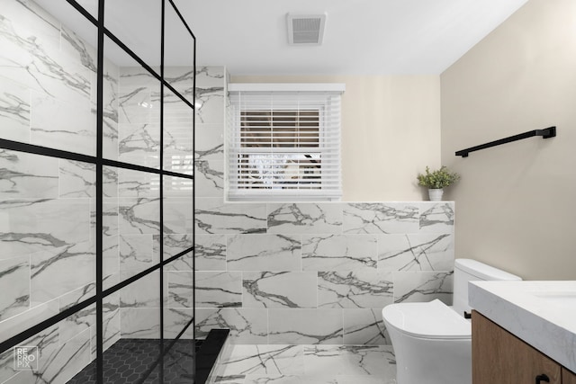 full bathroom with a marble finish shower, visible vents, toilet, and vanity