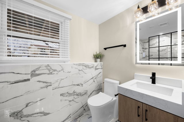 bathroom with visible vents, toilet, and vanity