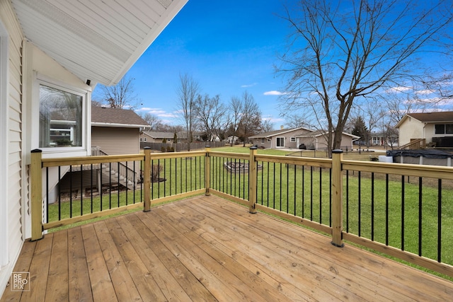 wooden terrace featuring a yard and a residential view