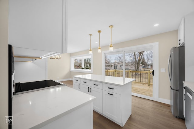 kitchen with light countertops, appliances with stainless steel finishes, dark wood-style flooring, and white cabinetry