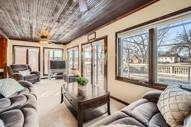 living room with baseboards, light carpet, wooden ceiling, and a ceiling fan