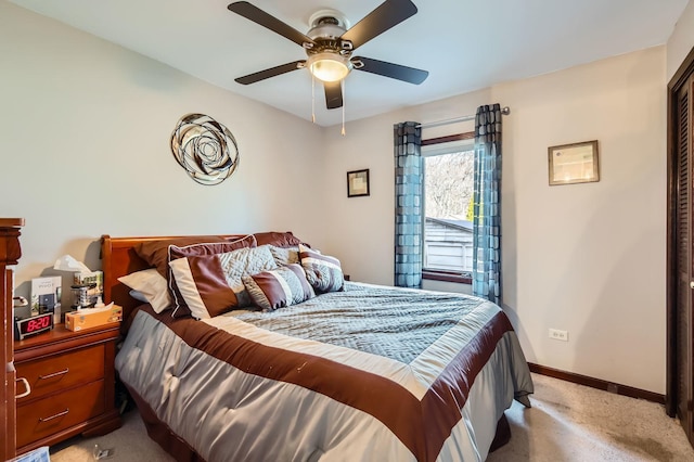 bedroom with light carpet, a ceiling fan, and baseboards