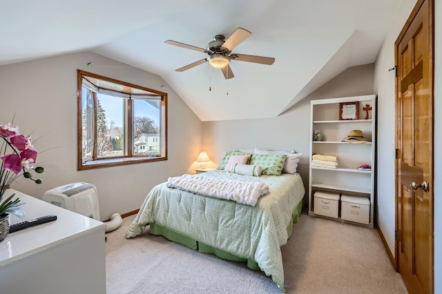 bedroom featuring light carpet, ceiling fan, and vaulted ceiling