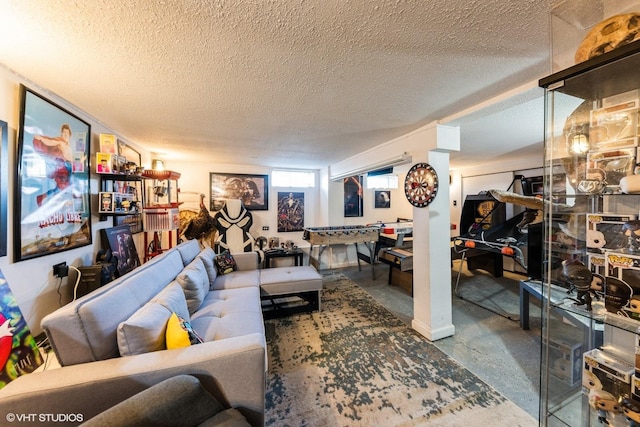 living area with a textured ceiling and concrete flooring