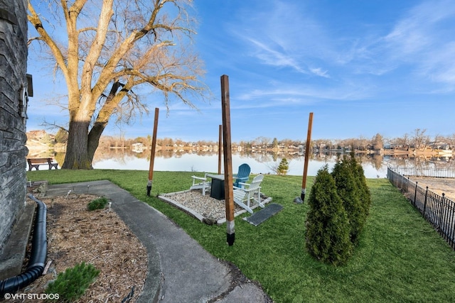 view of yard with a water view and fence