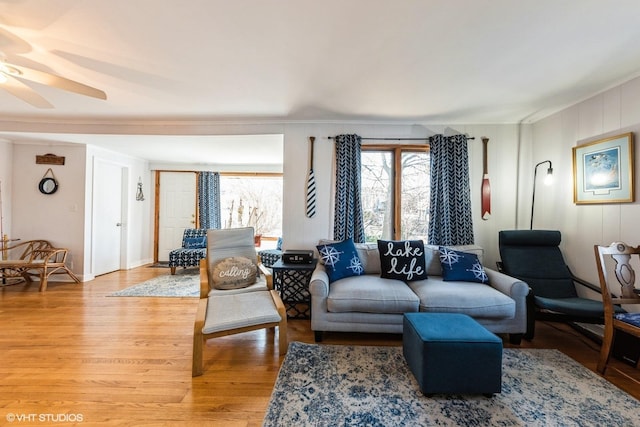 living area featuring light wood-style flooring and ceiling fan