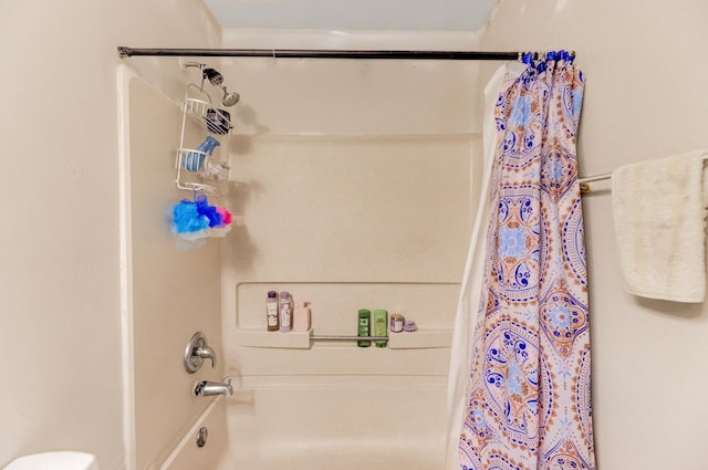 full bathroom featuring toilet and shower / bathtub combination with curtain