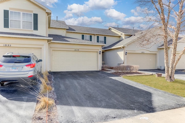 traditional-style home with driveway and a garage