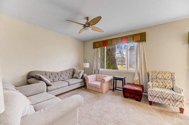 living area with a ceiling fan and carpet