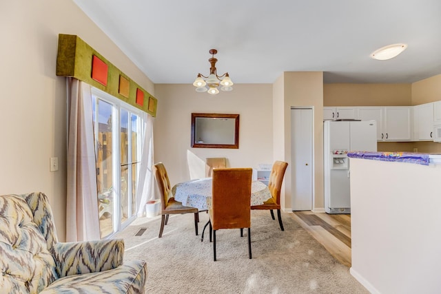 dining area featuring visible vents, a chandelier, and baseboards