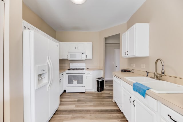 kitchen with white cabinets, white appliances, light wood-style flooring, and light countertops