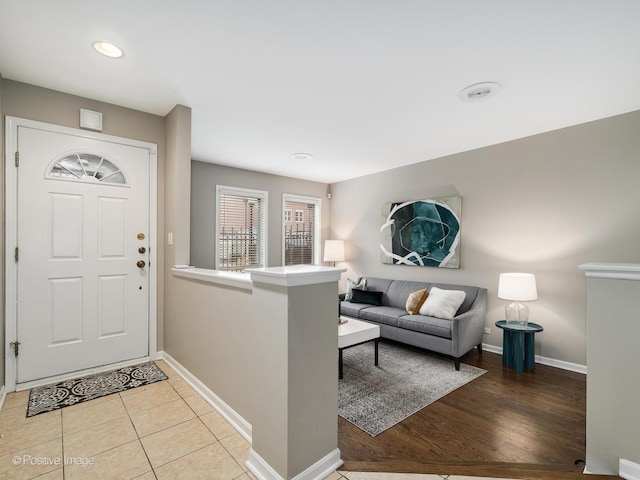 foyer entrance featuring light tile patterned floors and baseboards