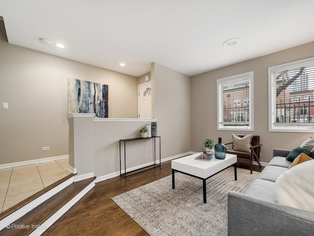 living room featuring recessed lighting, baseboards, and dark wood-style flooring