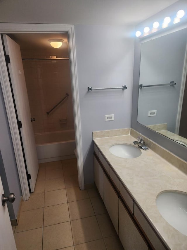 bathroom with double vanity, tile patterned flooring, shower / washtub combination, and a sink