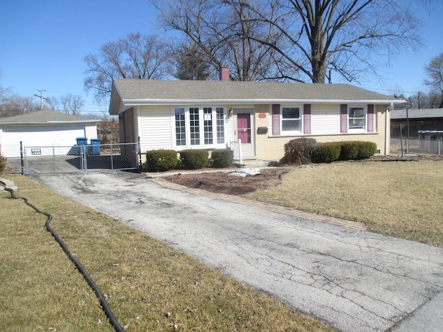 single story home featuring brick siding, a chimney, a front yard, a gate, and fence