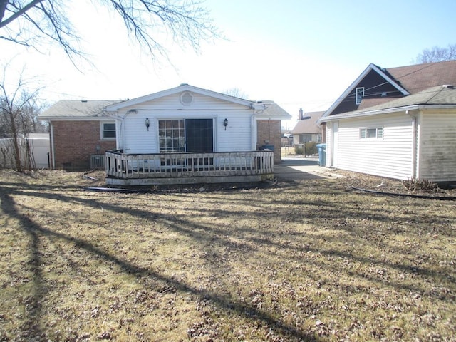 back of property featuring a yard, cooling unit, and a wooden deck