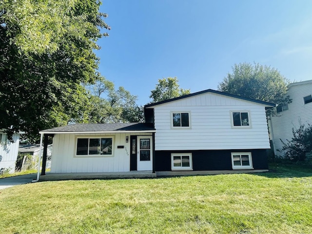 split level home featuring a front lawn