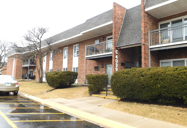 view of building exterior with uncovered parking