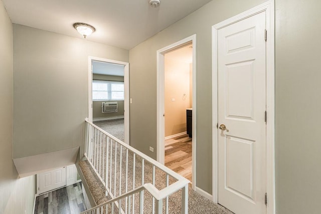 corridor with baseboards and wood finished floors