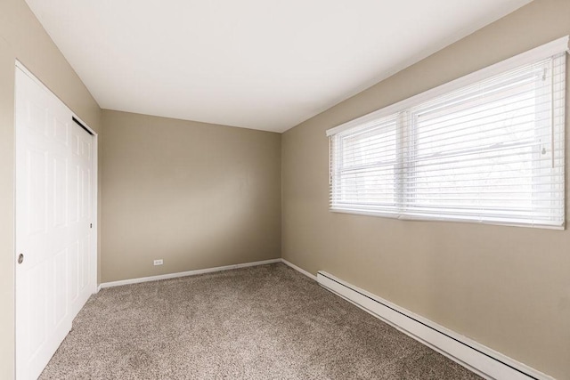 interior space featuring carpet, baseboards, baseboard heating, and a closet